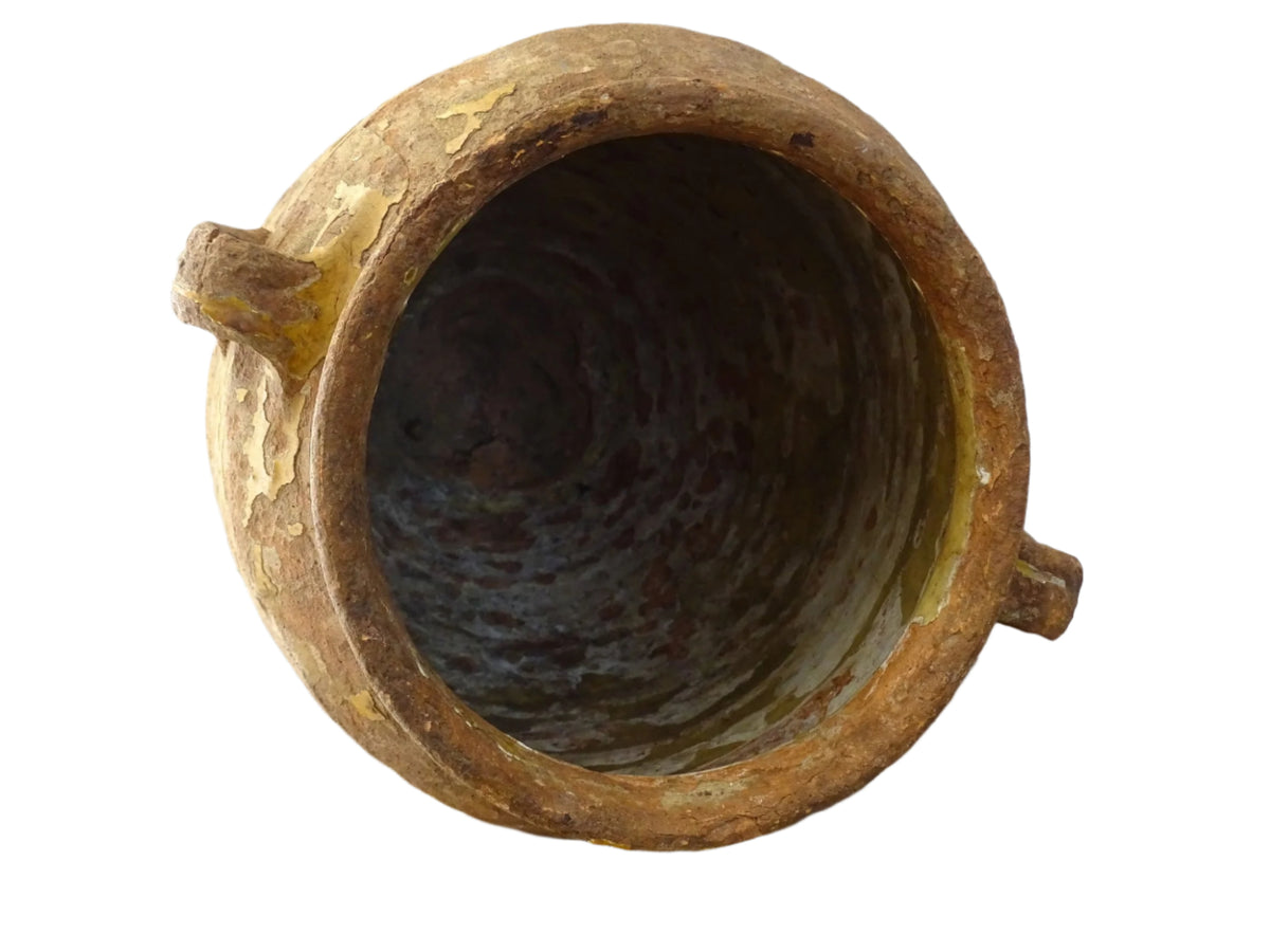 Antique French confit pot with yellow glaze, a large rustic terracotta pot or confit jar from the South of France.