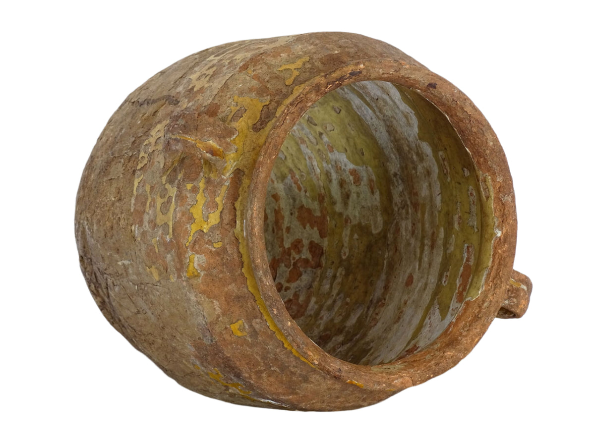 Antique French confit pot with yellow glaze, a large rustic terracotta pot from the South of France.