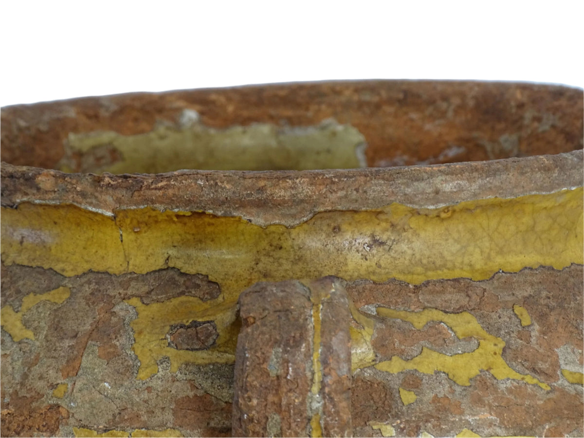 Antique French confit pot with yellow glaze, a large rustic terracotta pot or confit jar from the South of France.