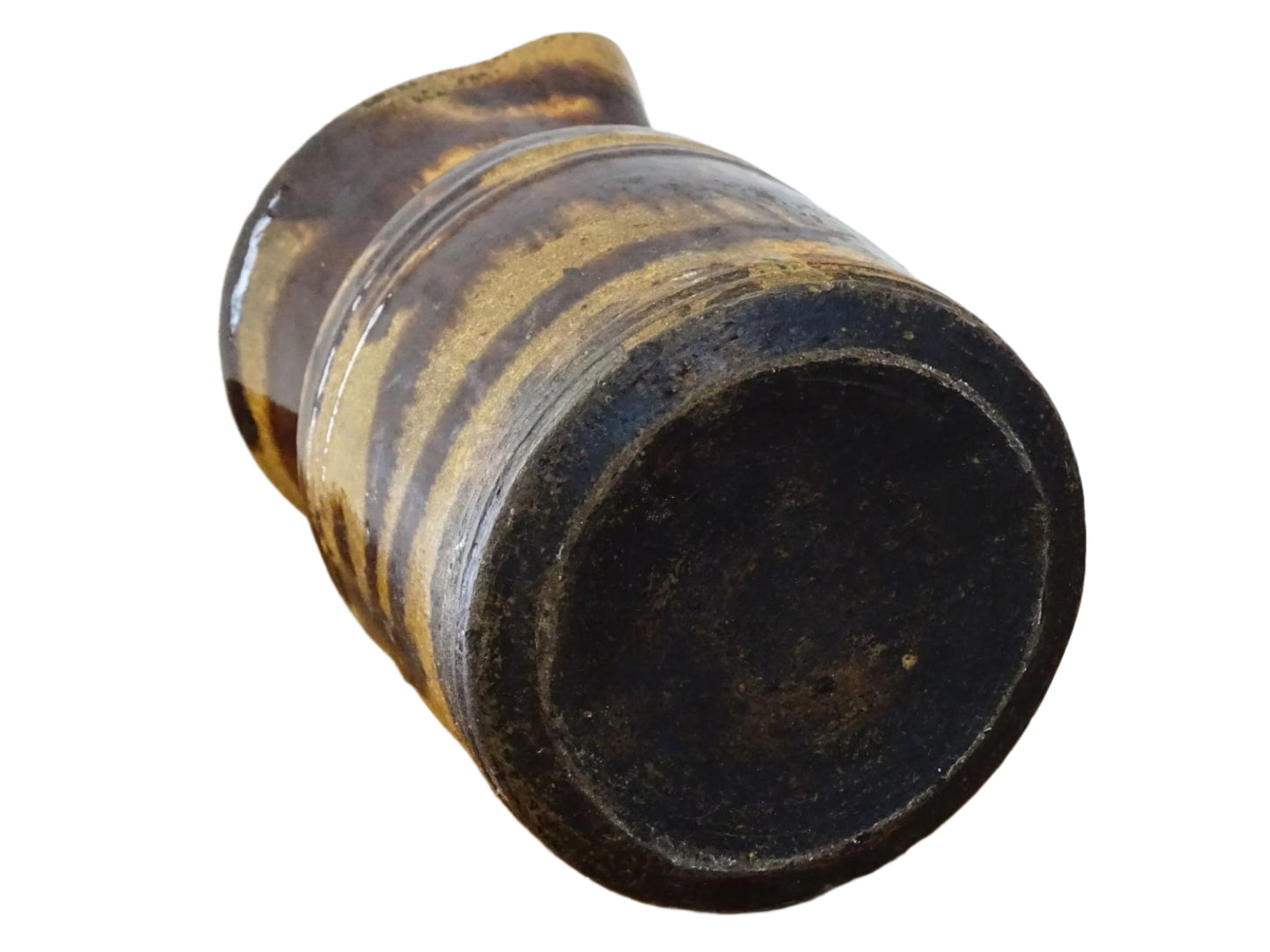 Rustic French antique ceramic jug with a brown drip glaze on a deep mustard colour background. Pottery jug from Dieulefit with a side spout. Rustic French pottery for a French farmhouse aesthetic.