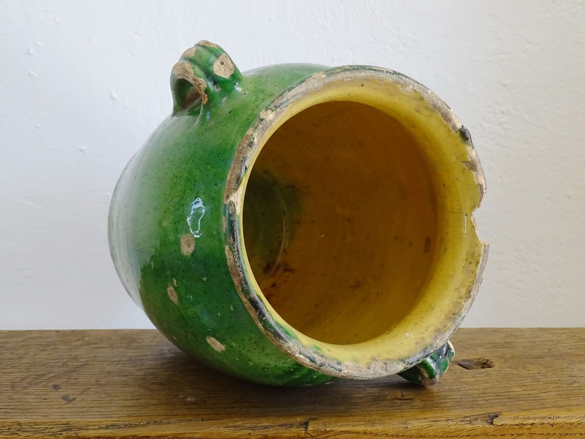 French antique confit pot with green glaze and yellow glazed interior. Green confit pot with two handles