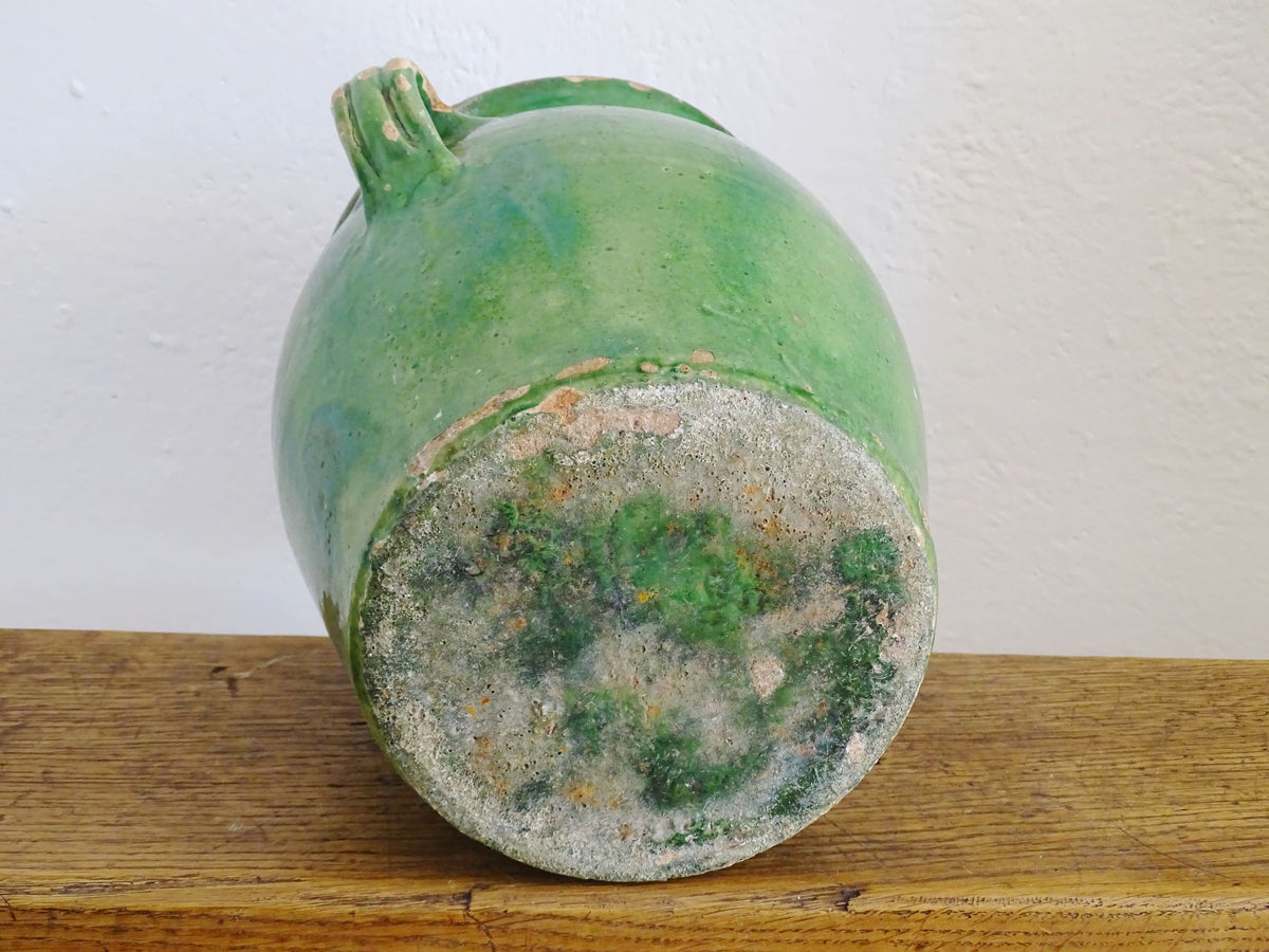 French antique confit pot with green glaze and yellow glazed interior. Green confit pot with two handles