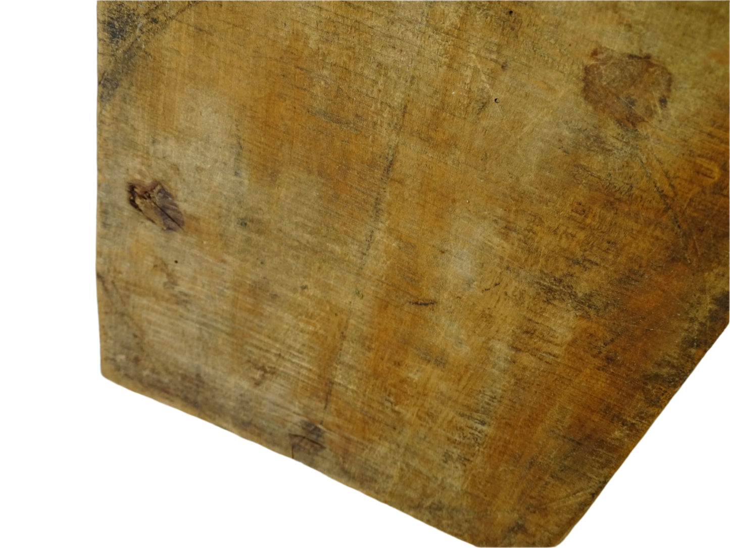 Close-up of a vintage wooden cutting board surface with visible grain and texture.