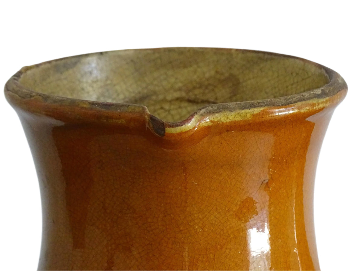 French antique terracotta jug with red glaze exterior and yellow glaze interior. Antique pottery pitcher with side handle and patina.