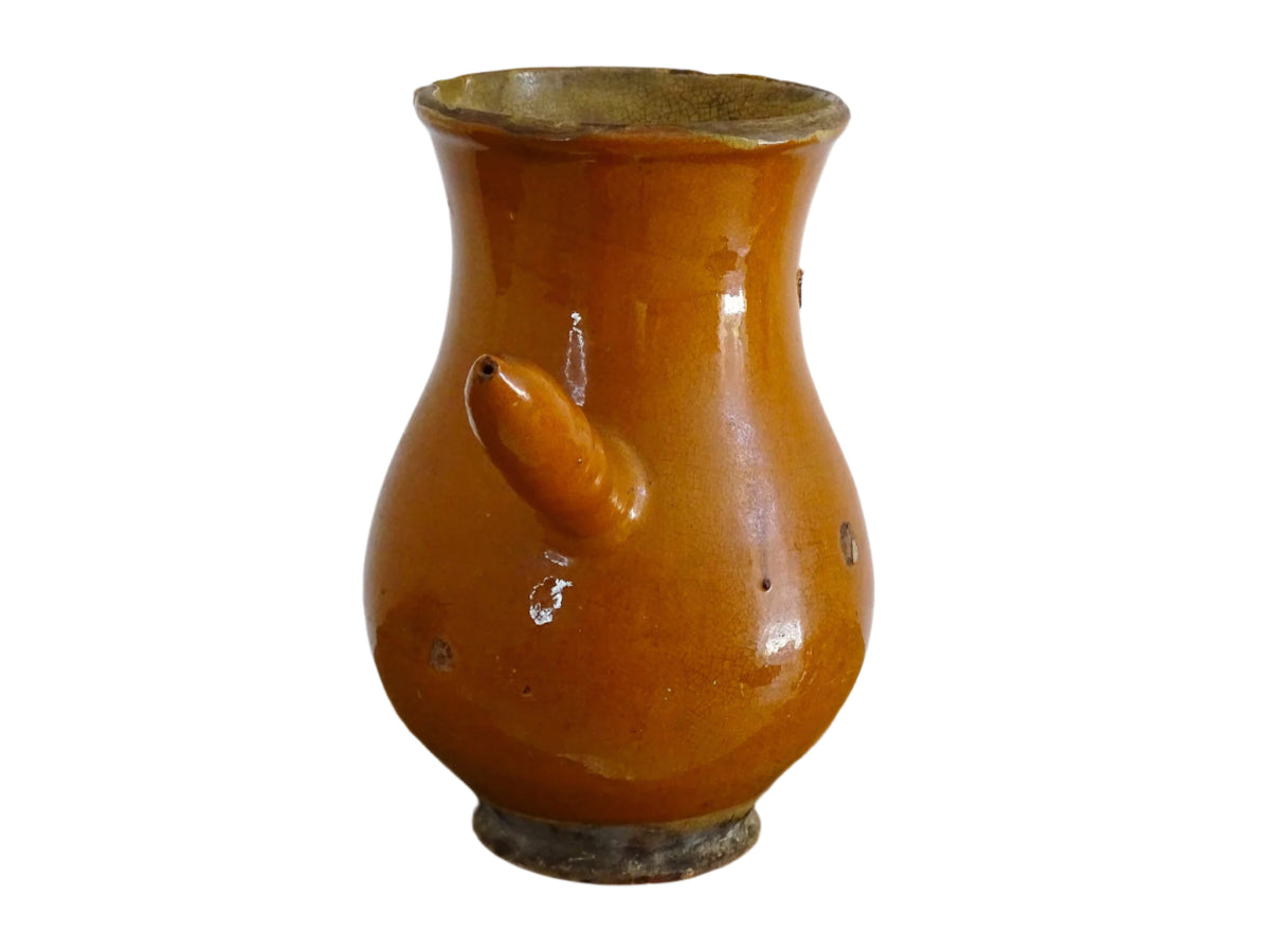 French antique terracotta jug with red glaze exterior and yellow glaze interior. Antique pottery pitcher with side handle and patina.