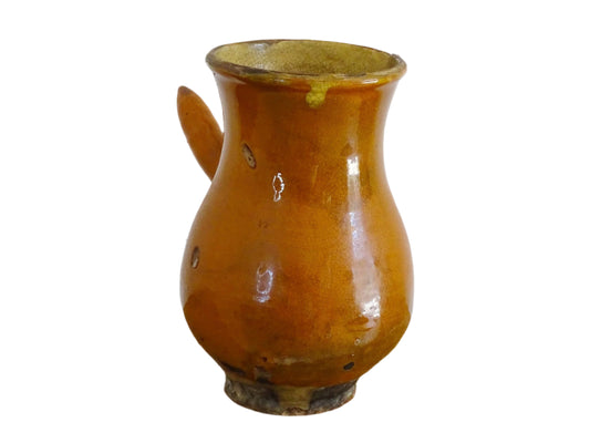 French antique terracotta jug with red glaze exterior and yellow glaze interior. Antique pottery pitcher with side handle and patina.