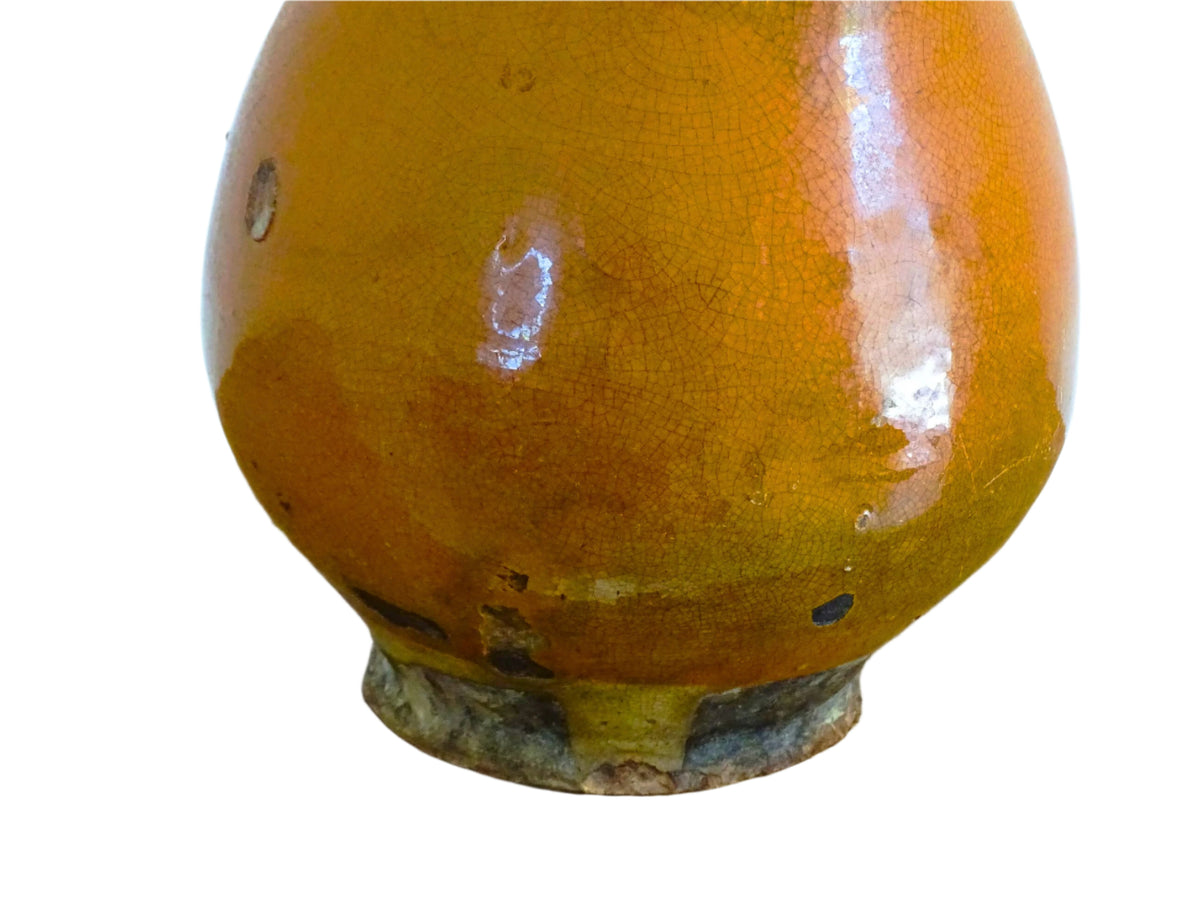French antique terracotta jug with red glaze exterior and yellow glaze interior. Antique pottery pitcher with side handle and patina.