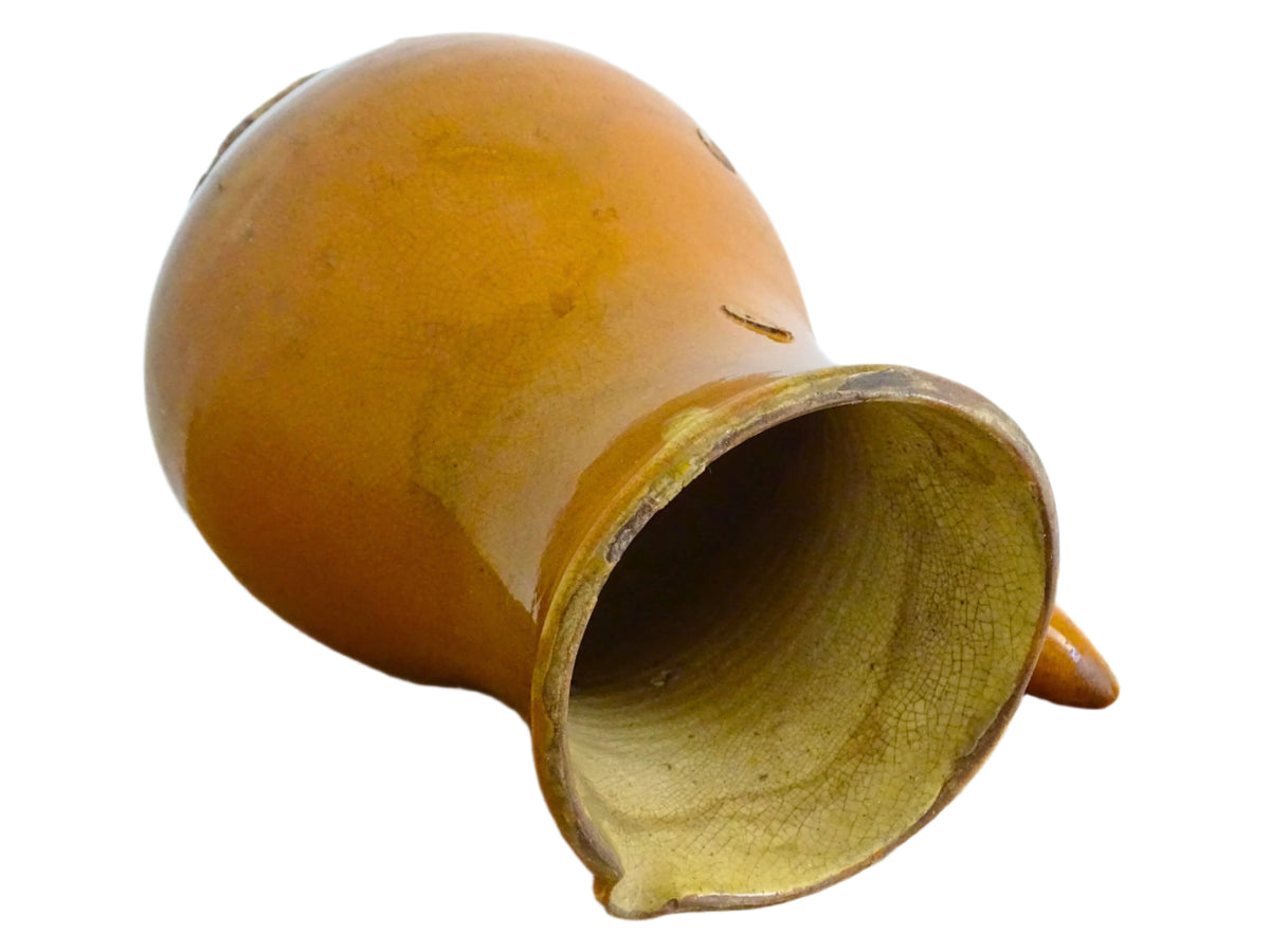 French antique terracotta jug with red glaze exterior and yellow glaze interior. Antique pottery pitcher with side handle and patina.
