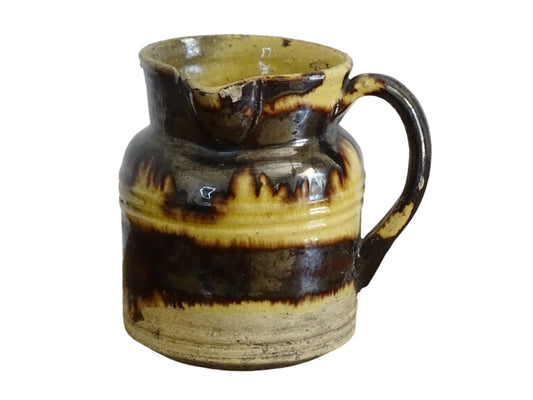 French antique ceramic jug from Dieulefit with brown drip glaze and yellow glazed background.
