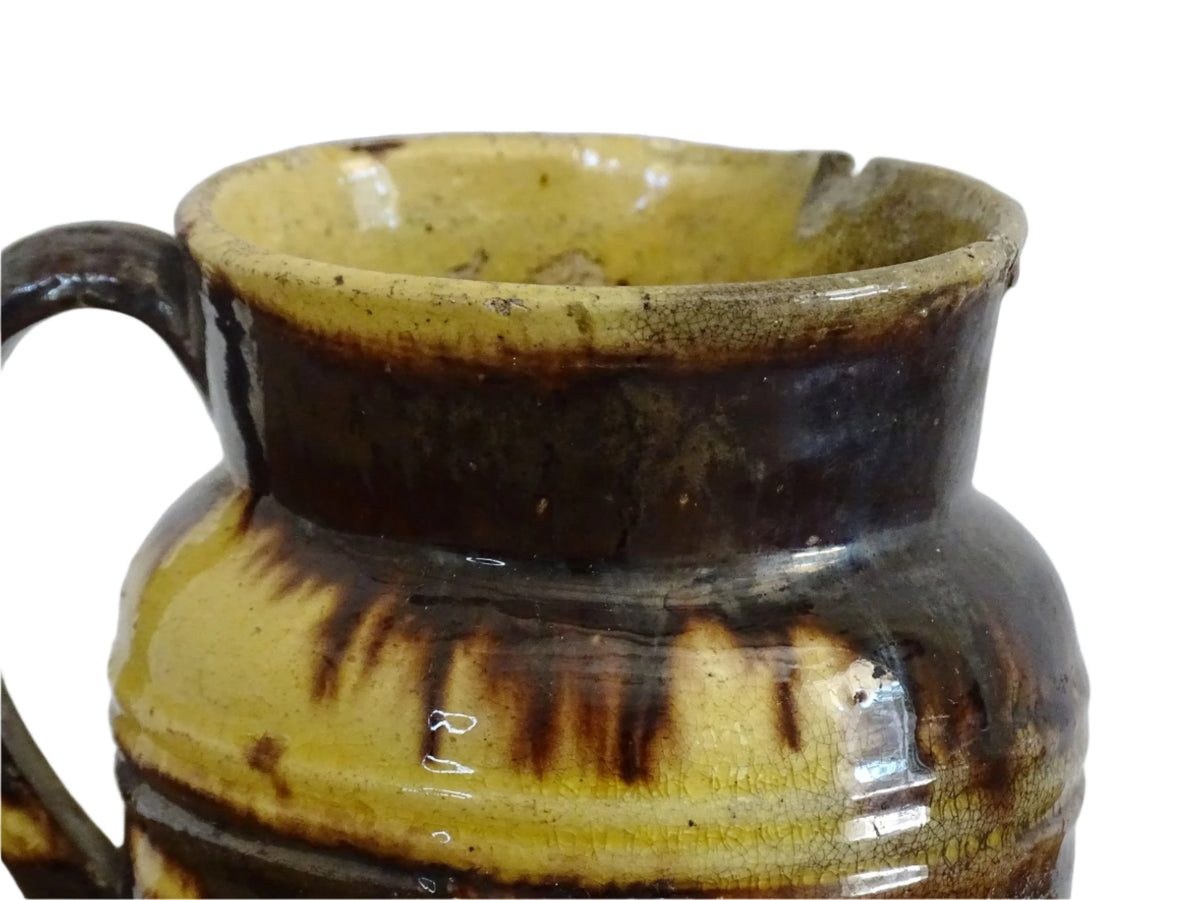 French antique ceramic jug from Dieulefit with brown drip glaze and yellow glazed background.