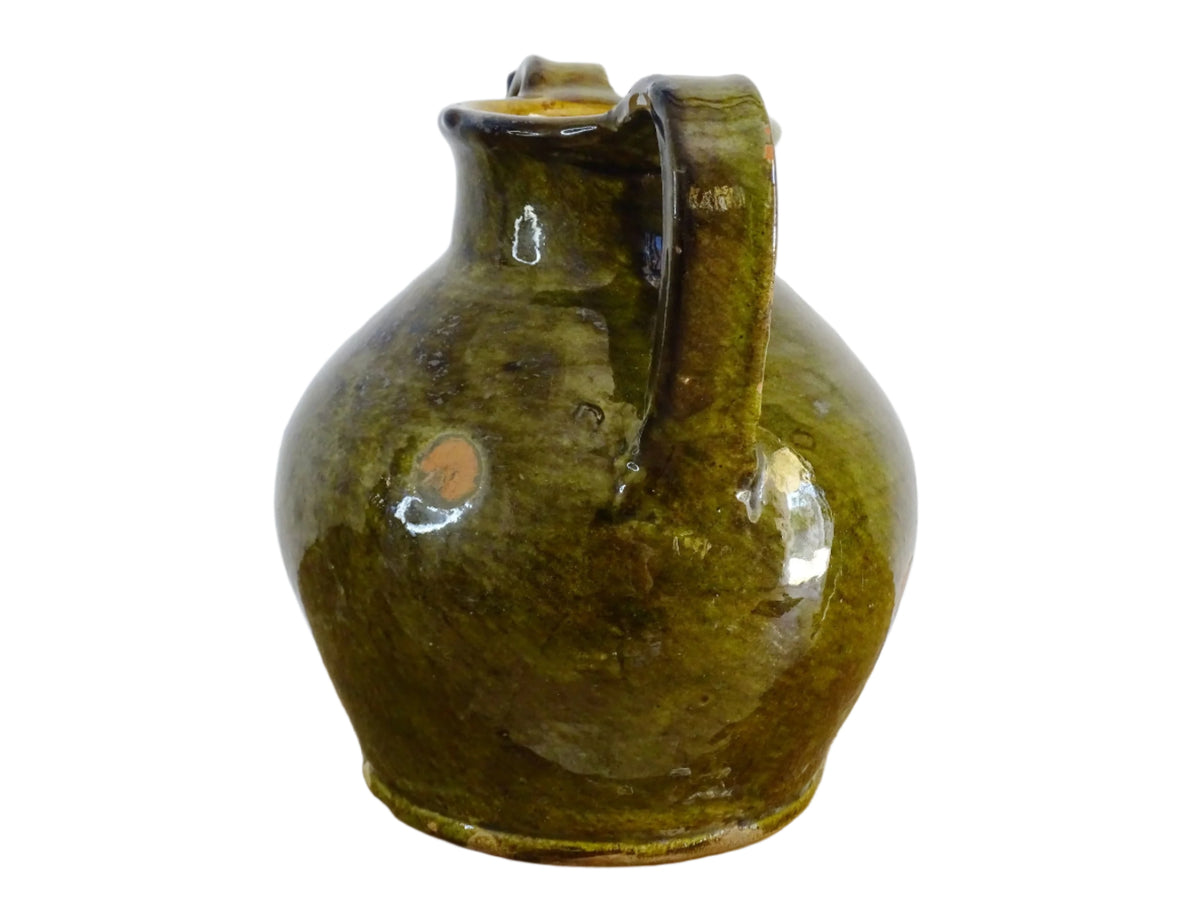 French antique cruche or orjol with an earthy green glaze. Antique terracotta water jug from the Languedoc with a timeworn appearance. French farmhouse aesthetic.