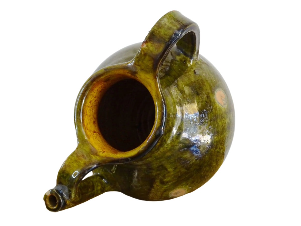 French antique cruche or orjol with an earthy green glaze. Antique terracotta water jug from the Languedoc with a timeworn appearance. French farmhouse aesthetic.
