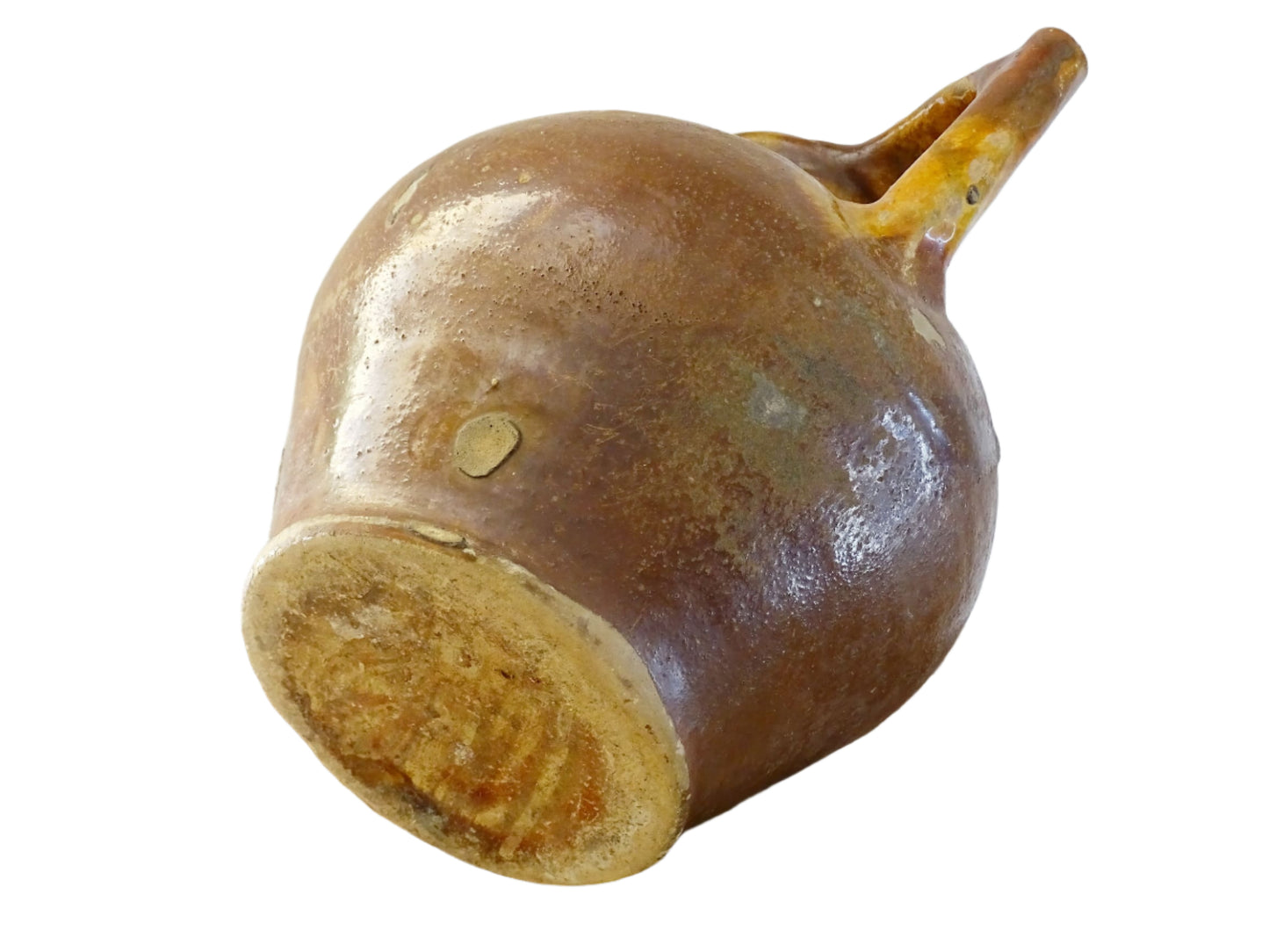French antique pottery orjol or cruche with a golden caramel and yellow glaze. Glazed antique terracotta pitcher has two handles and a spout with a rounded body. Earthenware pottery for an antique French farmhouse style aesthetic.