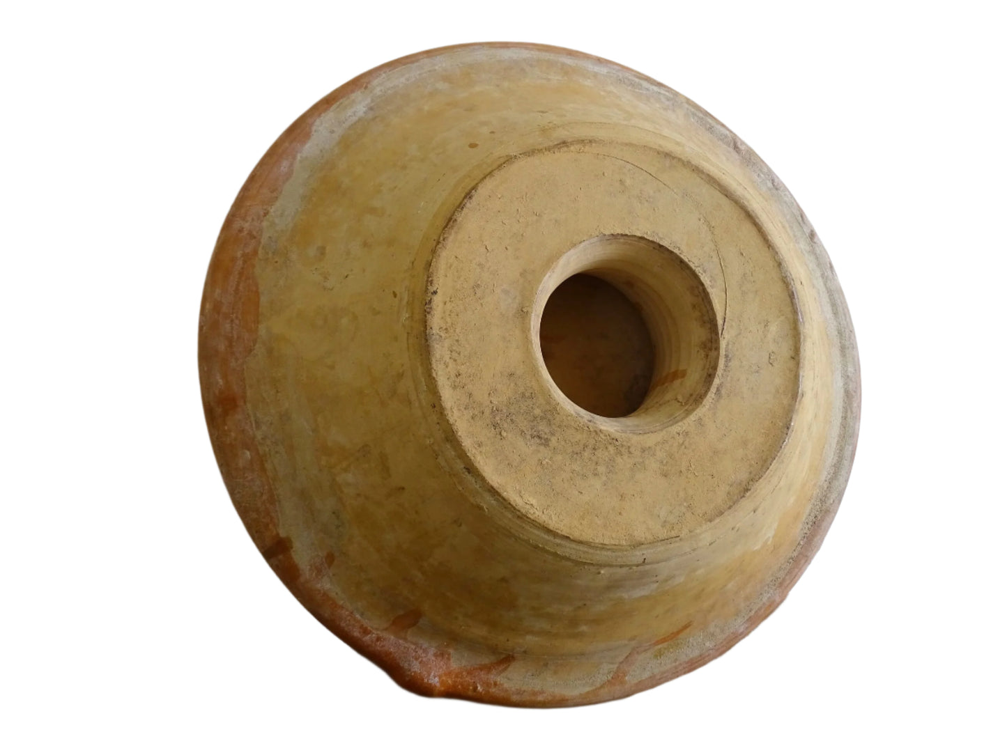 French antique pottery cheese strainer or faisseller. Shaped like a French tian bowl with a stand in the middle and a lip to the edge. Rustic French antique pottery bowl with an orange glaze. Glazed earthenware cheese drainer.