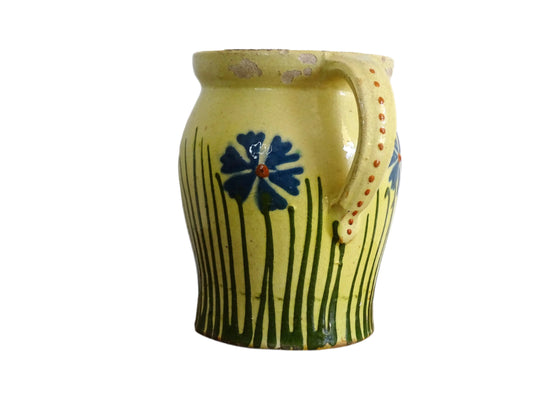 French antique pottery jug with hand painted flowers. Yellow glazed pitcher with blue flowers for a French farmhouse or cottagecore kitchen.
