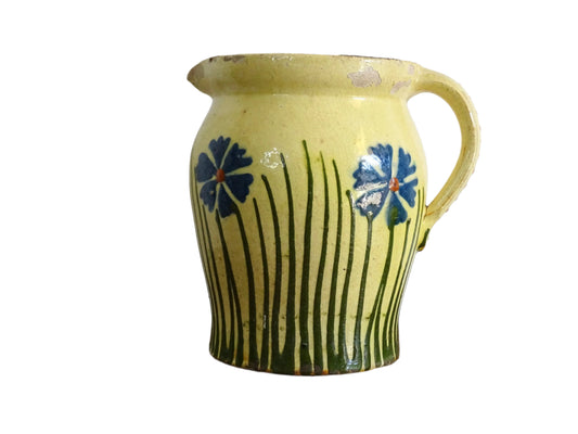 French antique pottery jug with hand painted flowers. Yellow glazed pitcher with blue flowers for a French farmhouse or cottagecore kitchen.