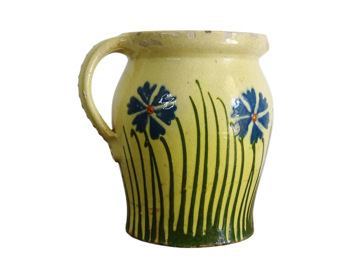 French antique pottery jug with hand painted flowers. Yellow glazed pitcher with blue flowers for a French farmhouse or cottagecore kitchen.