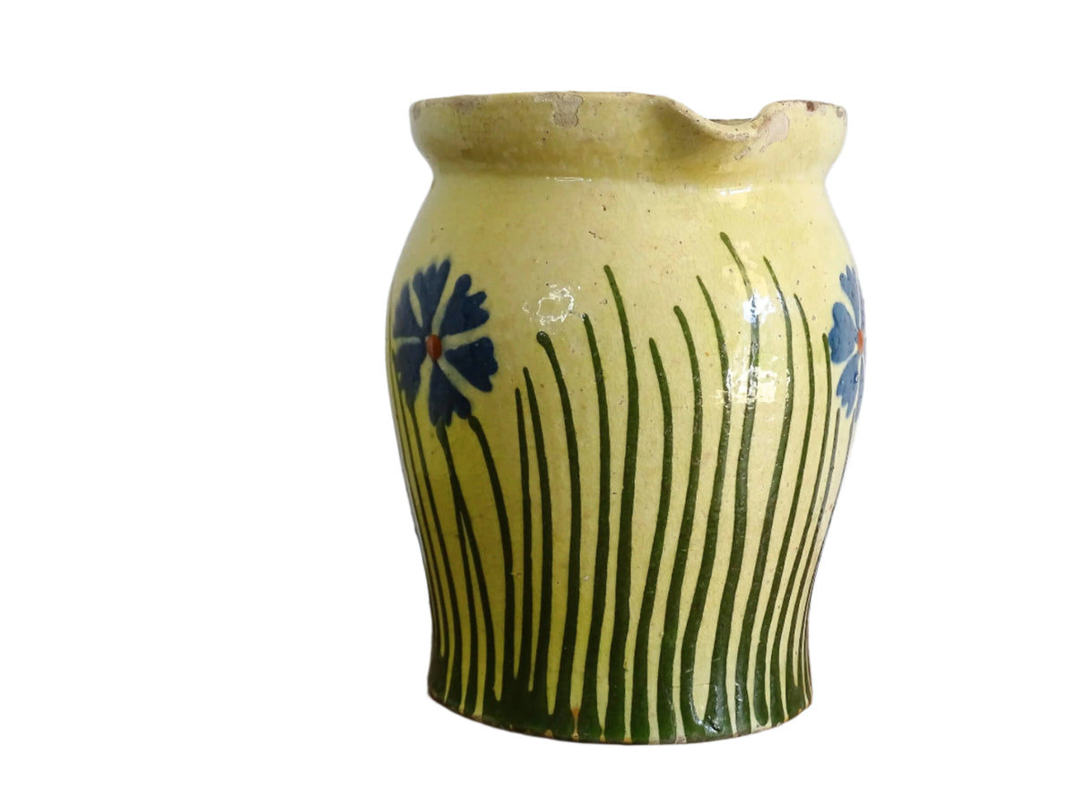 French antique pottery jug with hand painted flowers. Yellow glazed pitcher with blue flowers for a French farmhouse or cottagecore kitchen.
