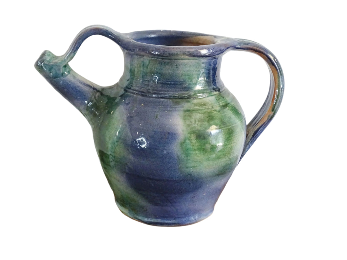 French vintage pottery jug or orjol with a soft blue and green glaze. Glazed terracotta water jug with spout and handle.