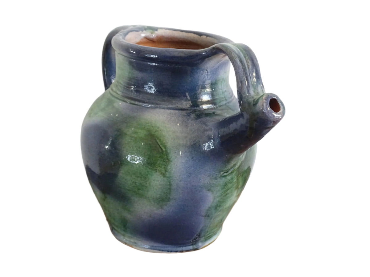 French vintage pottery jug or orjol with a soft blue and green glaze. Glazed terracotta water jug with spout and handle.