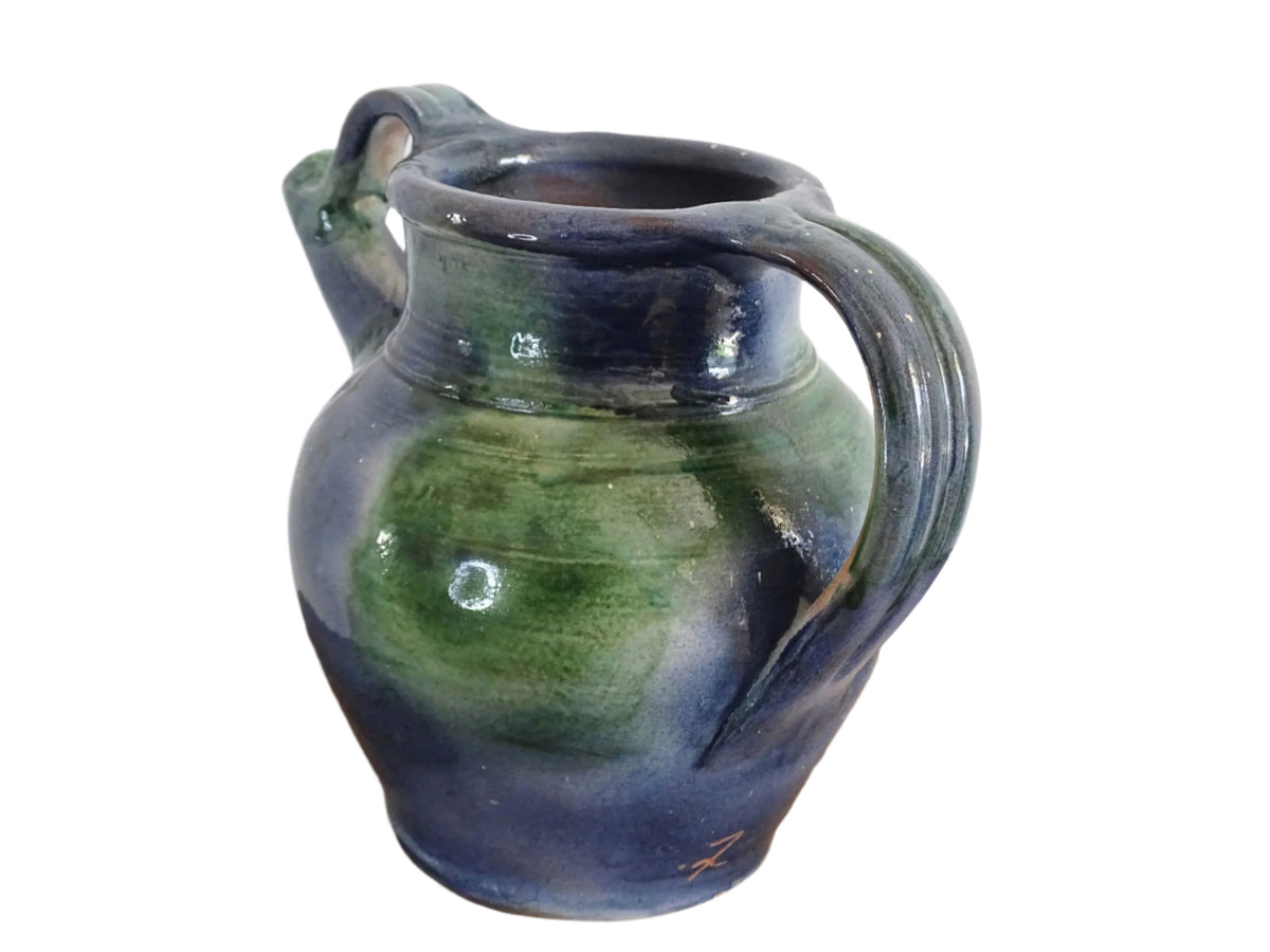 French vintage pottery jug or orjol with a soft blue and green glaze. Glazed terracotta water jug with spout and handle.