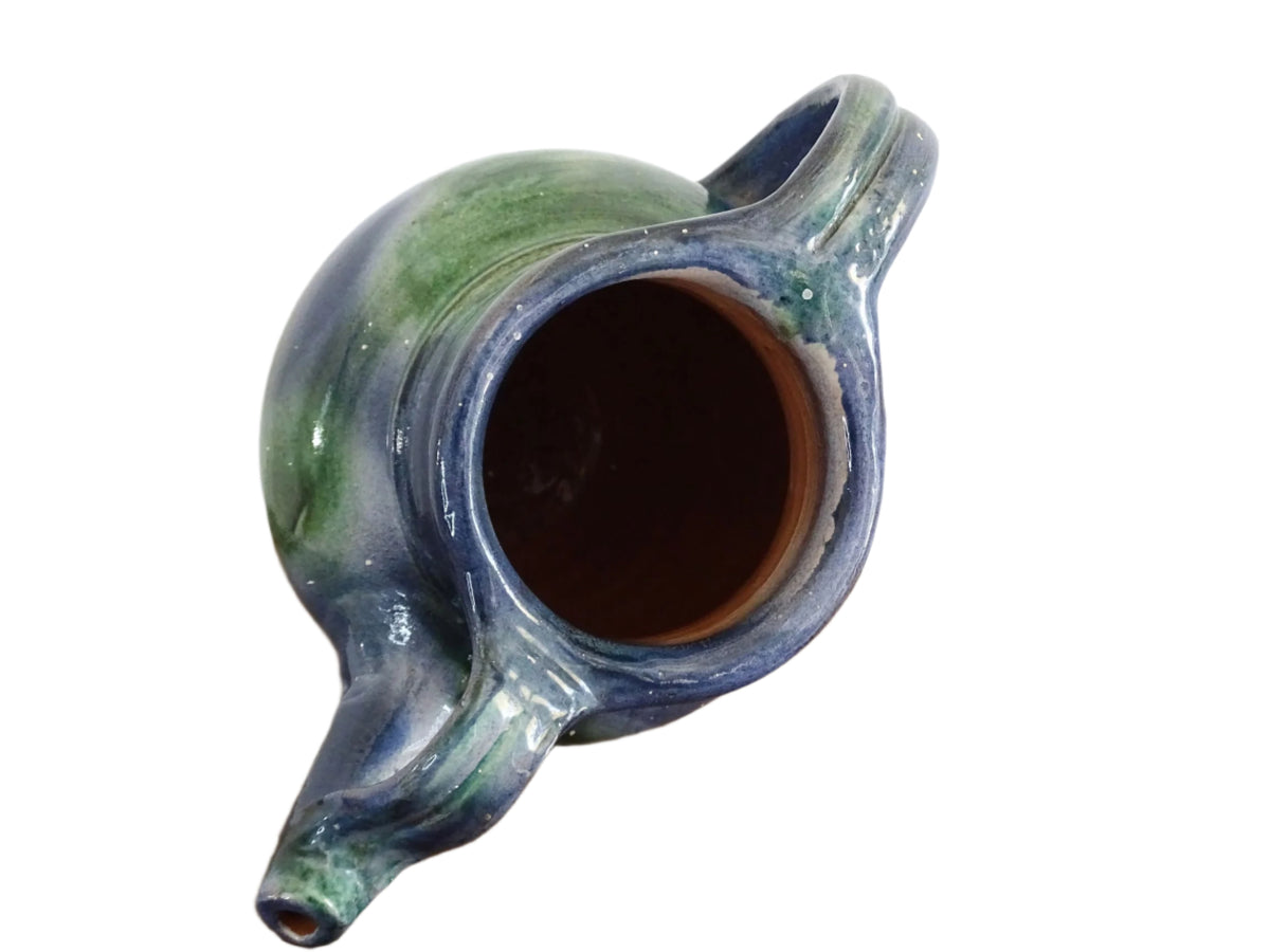 French vintage pottery jug or orjol with a soft blue and green glaze. Glazed terracotta water jug with spout and handle.