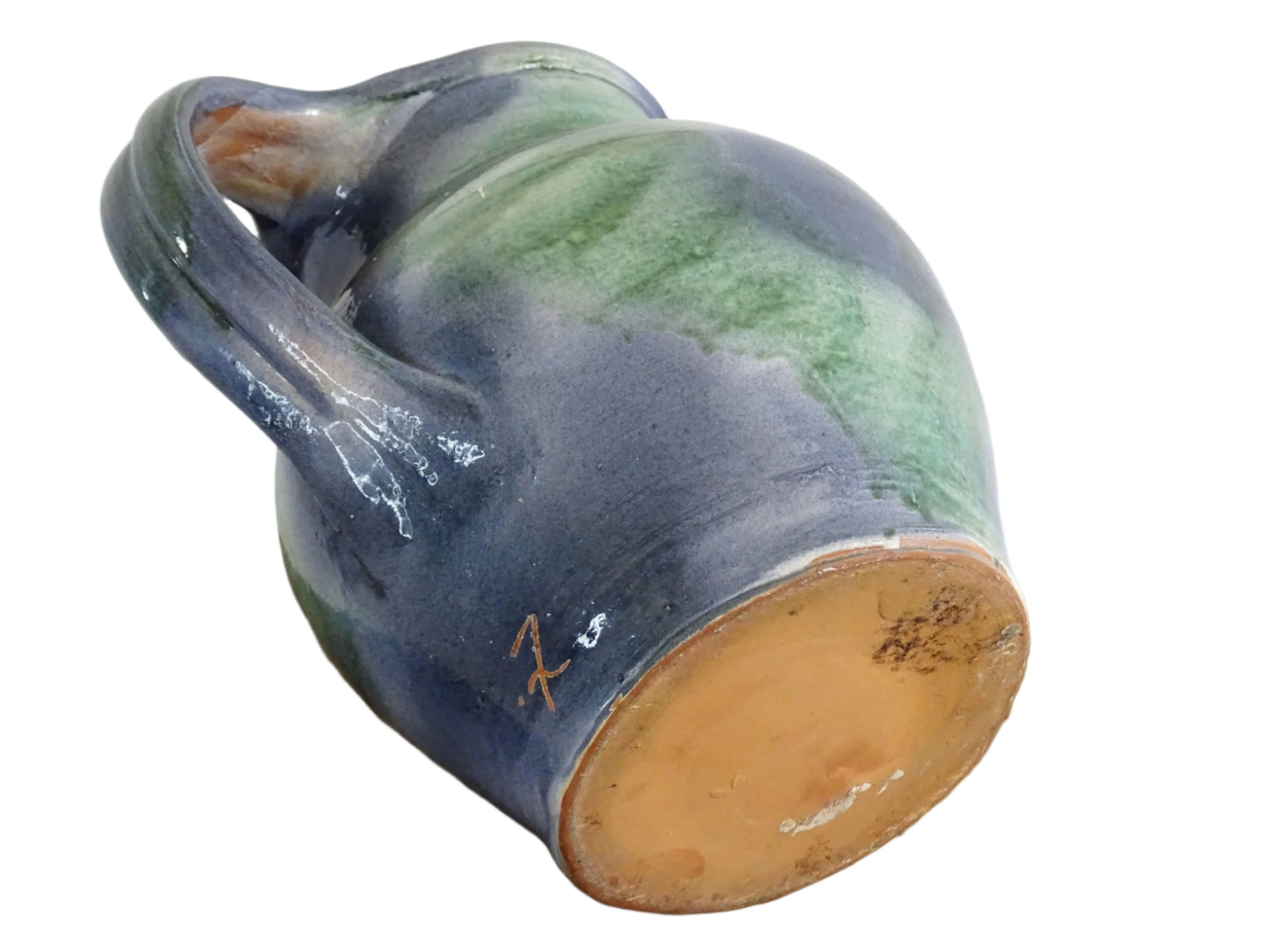 French vintage pottery jug or orjol with a soft blue and green glaze. Glazed terracotta water jug with spout and handle.