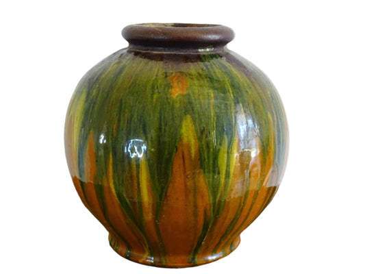 French antique ceramic vase glazed in orange with a yellow, green and brown drip glaze. Pottery vase with a rounded shape.