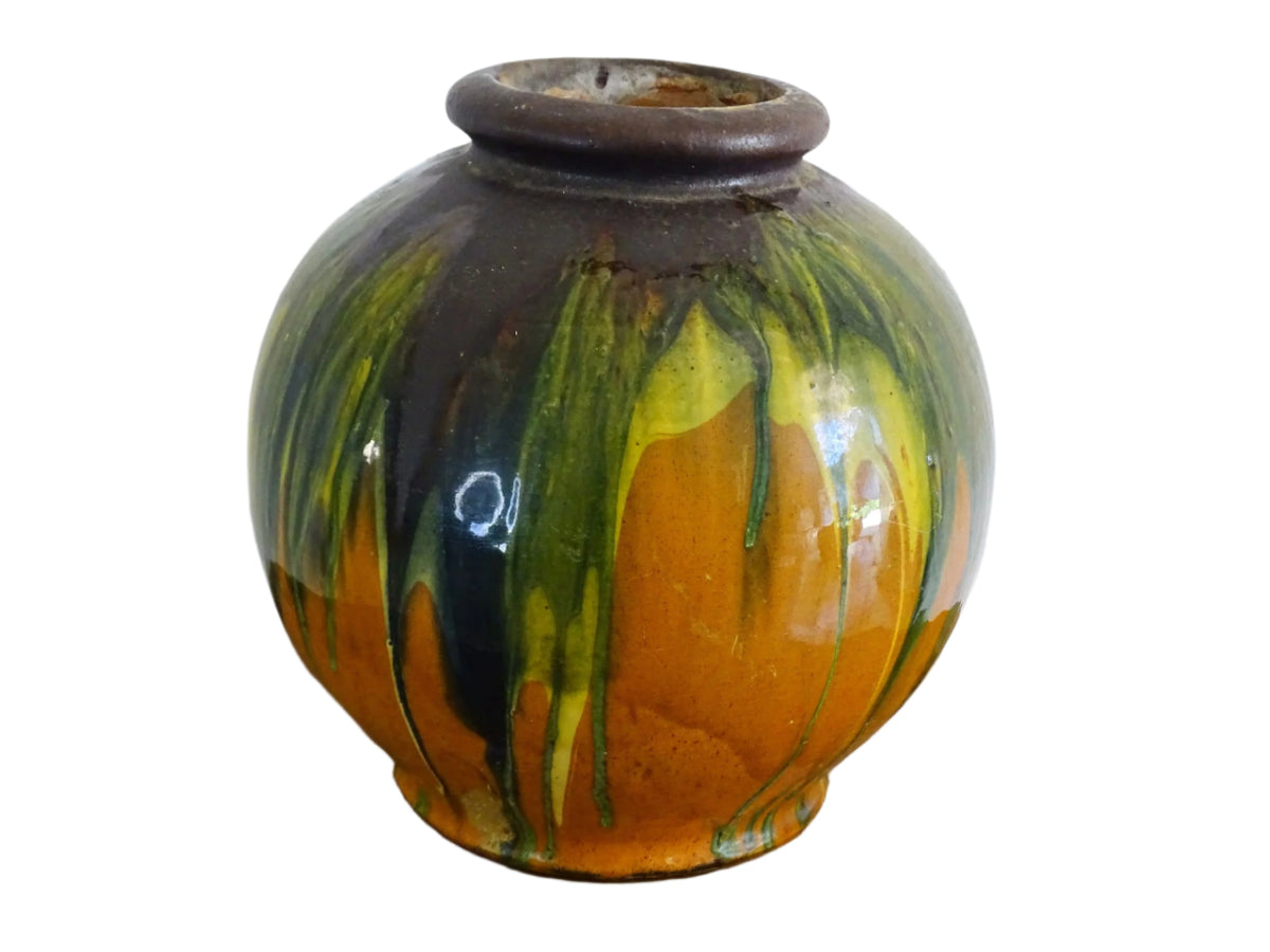 French antique ceramic vase glazed in orange with a yellow, green and brown drip glaze. Pottery vase with a rounded shape.
