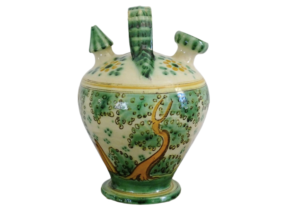 Decorated Spanish vintage gargoulette with a green and ochre yellow glaze. Puente Del Arzobispo pottery water pitcher is hand-painted with trees, a castle and flowers. It has a handle to the top, as well as two spouts. Ceramic pitcher or glazed terracotta jug.