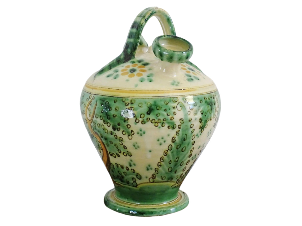 Decorated Spanish vintage gargoulette with a green and ochre yellow glaze. Puente Del Arzobispo pottery water pitcher is hand-painted with trees, a castle and flowers. It has a handle to the top, as well as two spouts. Ceramic pitcher or glazed terracotta jug.