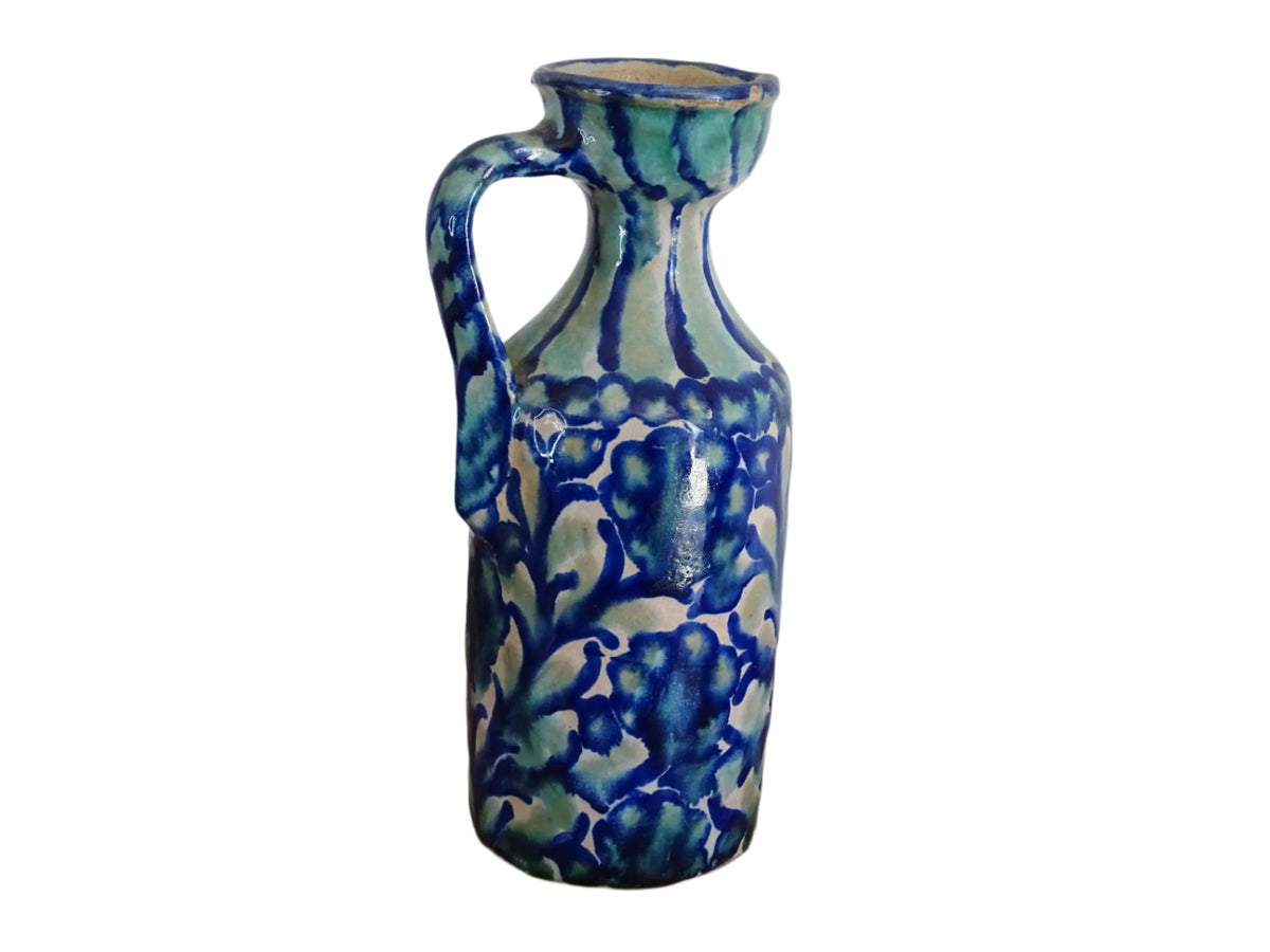 Spanish antique Fajalauza pottery jug, hand-painted in blue and green with a pink background. Decorated with stripes to the top and handle and flowers, leaves and a bird. Tin glazed terracotta pitcher.