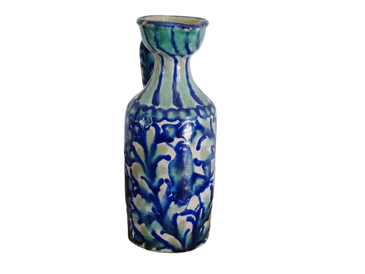 Spanish antique Fajalauza pottery jug, hand-painted in blue and green with a pink background. Decorated with stripes to the top and handle and flowers, leaves and a bird. Tin glazed terracotta pitcher.