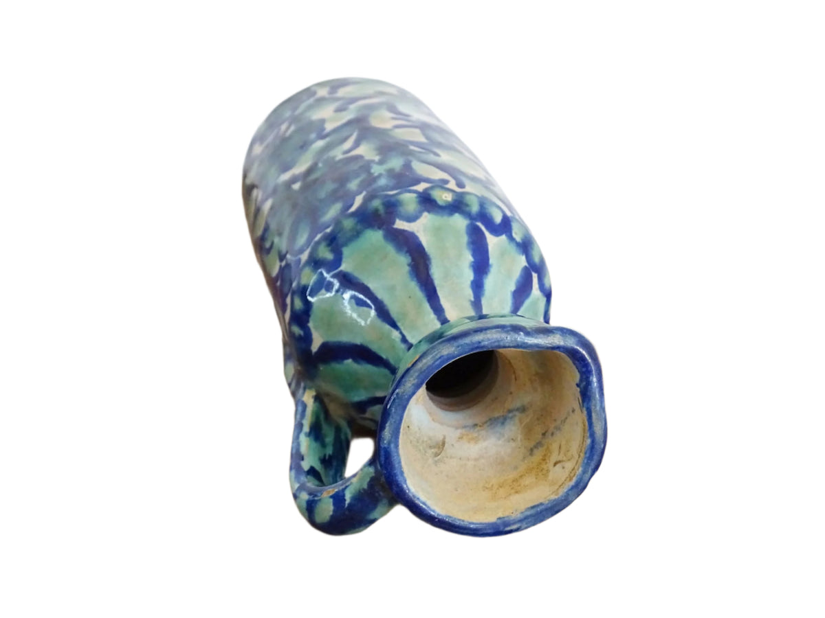 Spanish antique Fajalauza pottery jug, hand-painted in blue and green with a pink background. Decorated with stripes to the top and handle and flowers, leaves and a bird. Tin glazed terracotta pitcher.