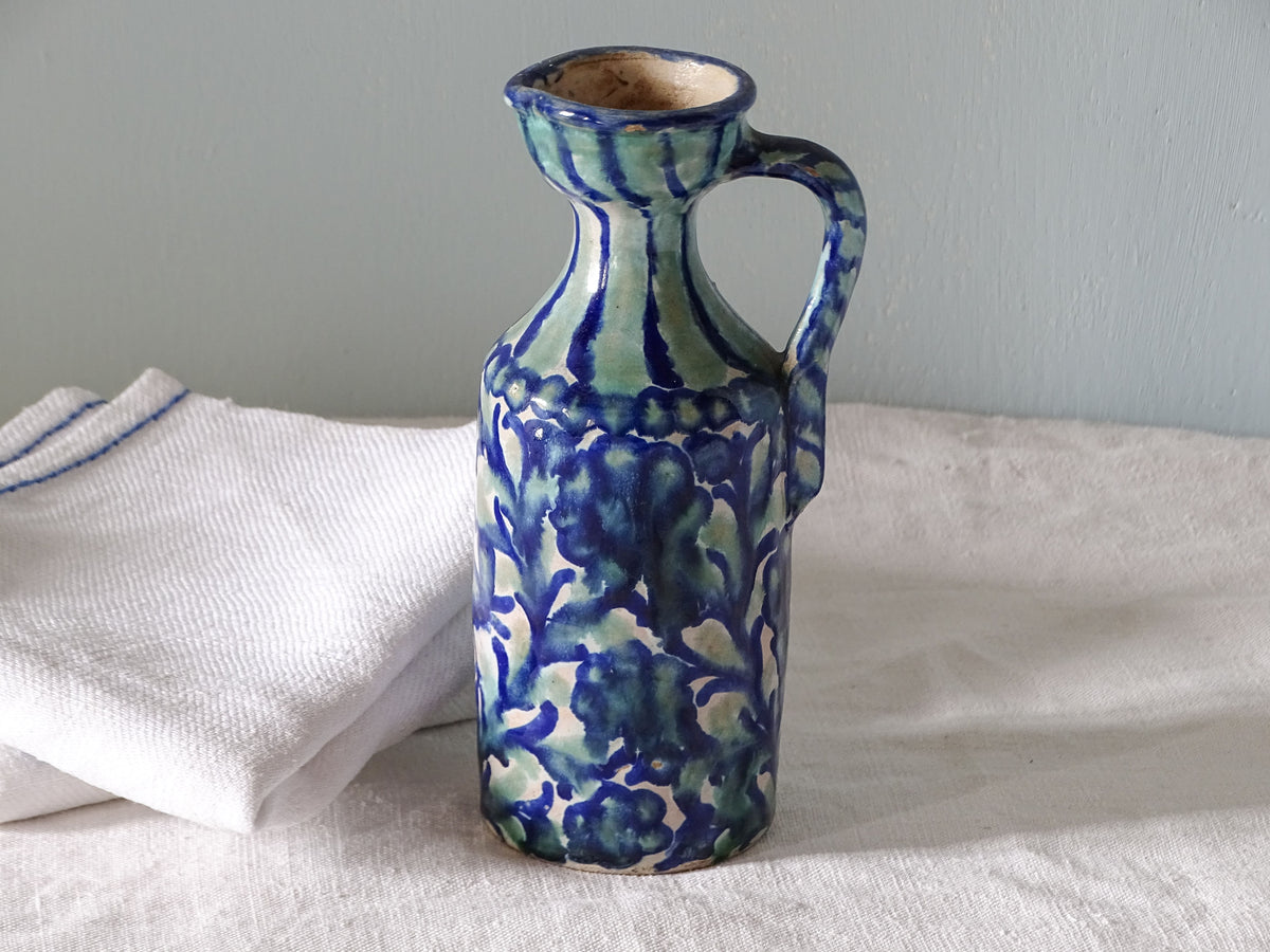 Spanish antique fajalauza pottery pitcher with hand-painted floral decoration in a blue and green glaze