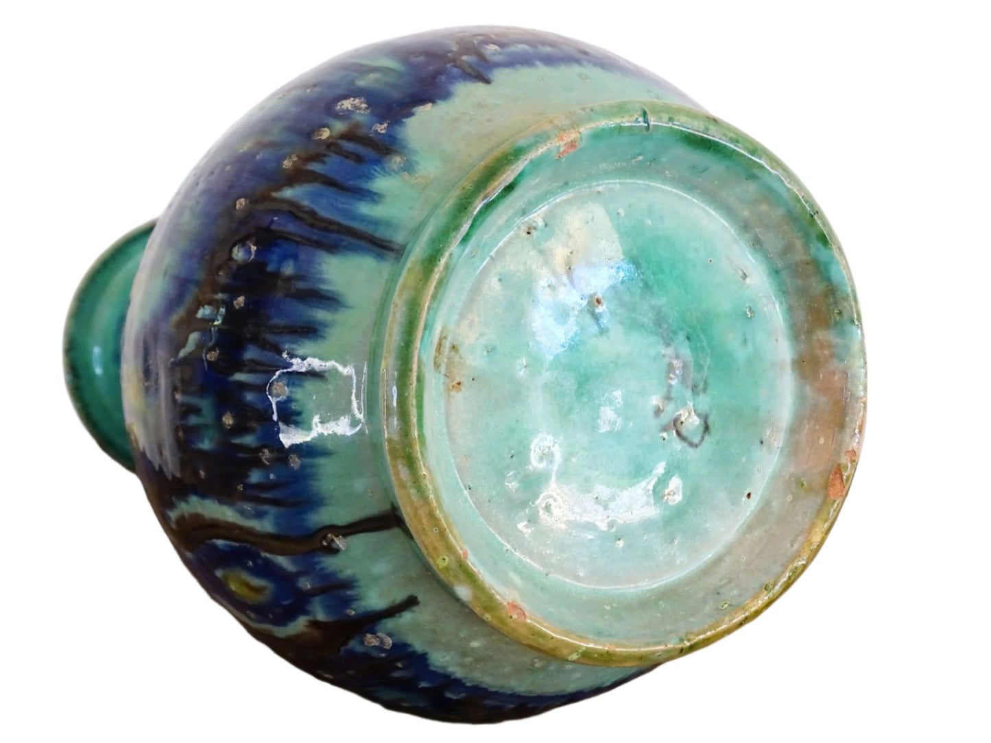 A French vintage ceramic vase lamp base with a bold, multicolored glaze in deep blue, green, and yellow. The organic, dripping pattern covers the surface, giving it a fluid, textured look. The vase has a rounded body that tapers towards a narrower neck, fitted with a brass lamp attachment. It rests on a slightly elevated base.