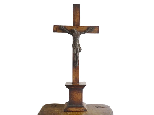 A French antique altar crucifix featuring a wooden cross with a spelter figure of Christ, mounted on a tiered wooden base. The wood has a rich patina.
