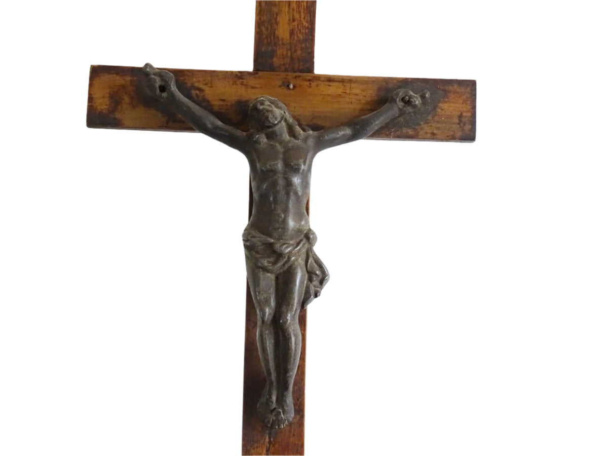 A French antique altar crucifix featuring a wooden cross with a spelter figure of Christ, mounted on a tiered wooden base. The wood has a rich patina.