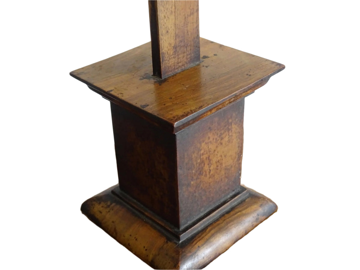 A French antique altar crucifix featuring a wooden cross with a spelter figure of Christ, mounted on a tiered wooden base. The wood has a rich patina.