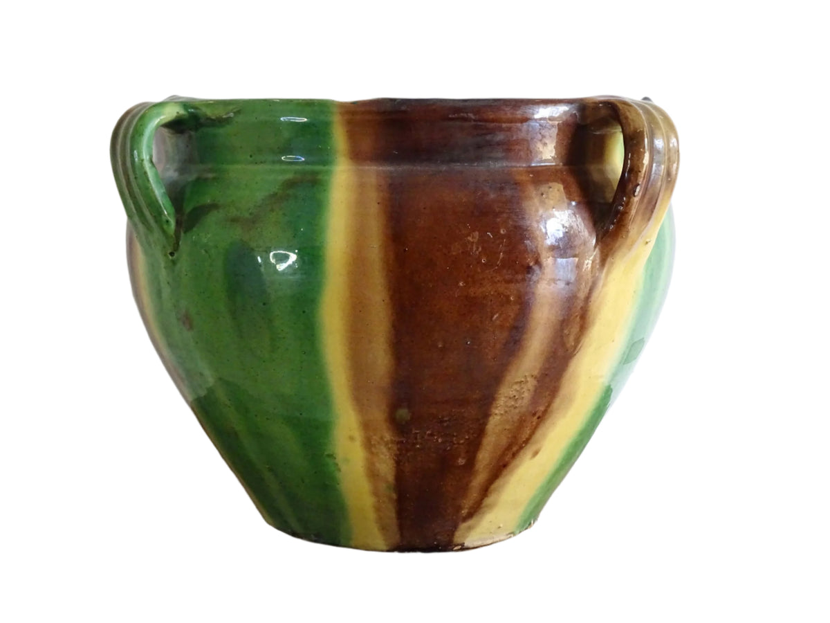 French antique ceramic planter from Castelnaudary. Pottery pot with a stripe drip glaze in yellow, green and brown. This antique cache pot in terracotta.