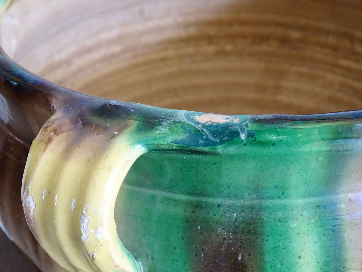 French antique ceramic planter from Castelnaudary. Pottery pot with a stripe drip glaze in yellow, green and brown. This antique cache pot in terracotta.