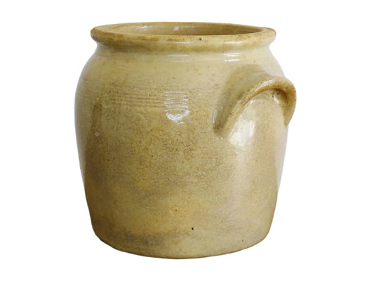 Rustic French antique stoneware confit jar with a beige glaze. Pottery cache pot dates to the early 20th century. Old preserving jar or utensils holder for farmhouse kitchen decor.