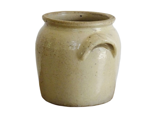 Rustic antique French stoneware confit jar or utensil holder. Glazed pottery cache pot with a beige glaze for a French farmhouse style home.