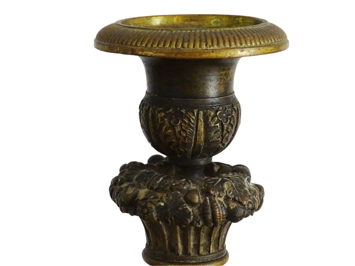 French antique bronze candle holders. French restoration period candlesticks are on a tripod base with lion paw feet and acanthus leaves. Acanthus leaves and various fruits and berries adorn the top of the reeded columns.