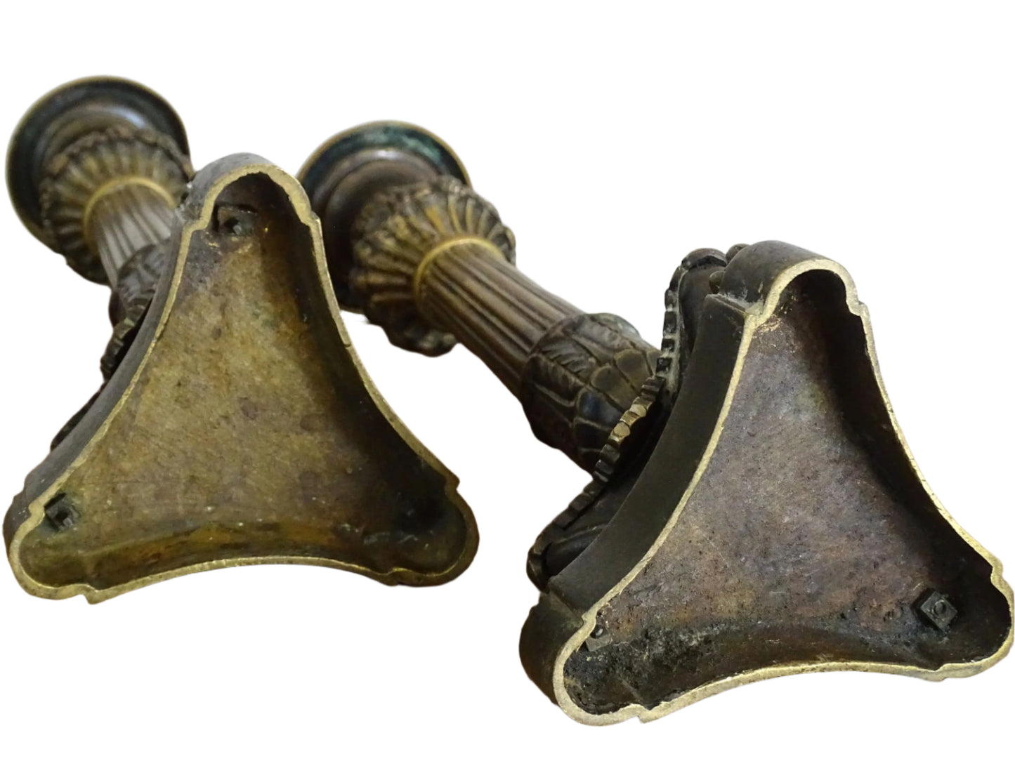 French antique bronze candle holders. French restoration period candlesticks are on a tripod base with lion paw feet and acanthus leaves. Acanthus leaves and various fruits and berries adorn the top of the reeded columns.