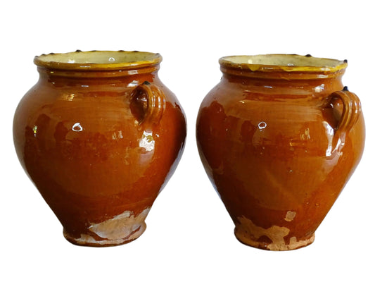 Pair of French antique confit pot vases with an orange glaze to the exterior and a yellow glaze to the interior for preserving food. Ceramic jars for rustic farmhouse decor. Orange and yellow glazed terracotta vases.