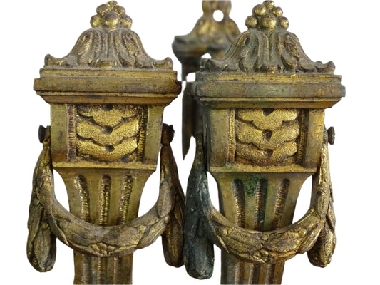 Pair of French antique curtain hooks in gilt bronze with intricate detailing. Empire style hooks with intricate acanthus leaf motifs and architectural elements.