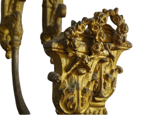 Pair of French antique curtain holdbacks in gilt bronze. Highly ornate, a garland of roses adorn the ends, and scrolls decorate the bars. Antique ormolu hardware.