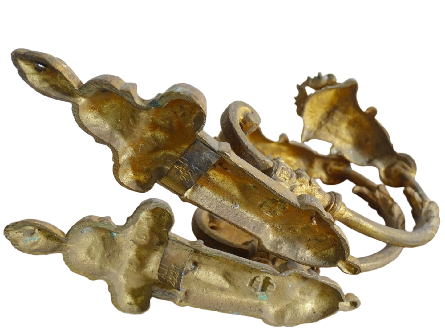 Pair of French antique curtain holdbacks in gilt bronze. Highly ornate, a garland of roses adorn the ends, and scrolls decorate the bars. Antique ormolu hardware.