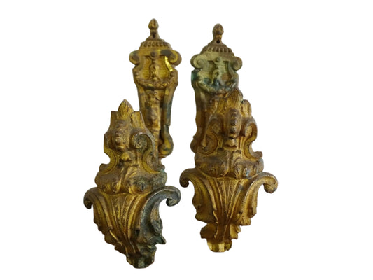 Pair of French antique curtain holdbacks in rococo style. Gilt bronze hooks adorned with swirling, acanthus leaf motifs